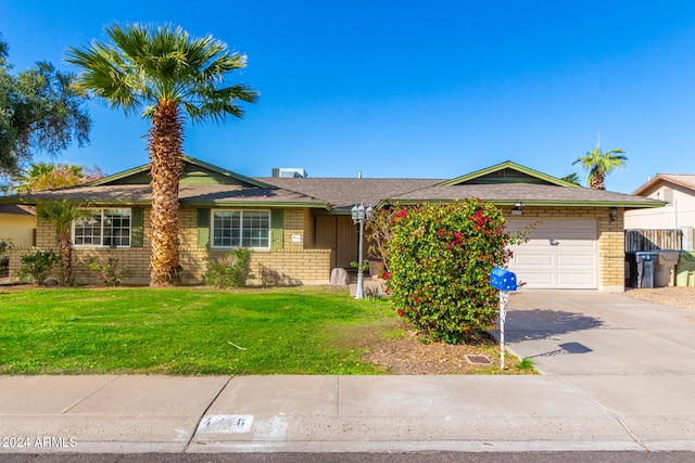 ranch-style house with a front yard and a garage