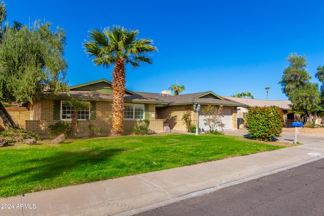 single story home featuring a front yard and a garage