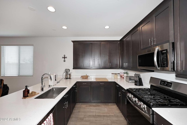 kitchen featuring stainless steel appliances, sink, and dark brown cabinets