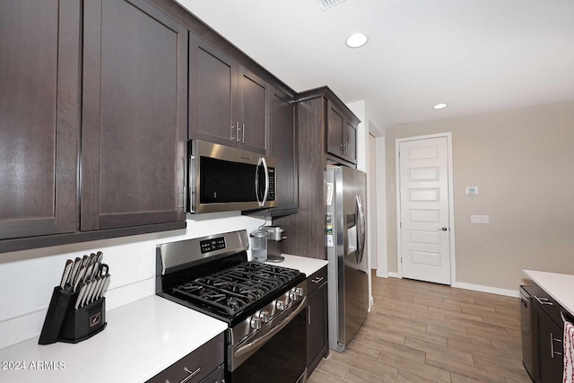 kitchen featuring light hardwood / wood-style floors, stainless steel appliances, and dark brown cabinets