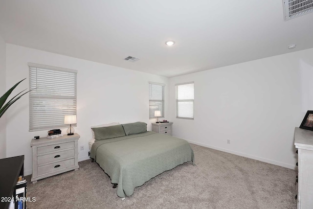 bedroom featuring light carpet