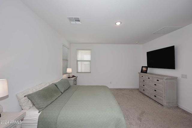 bedroom with light colored carpet