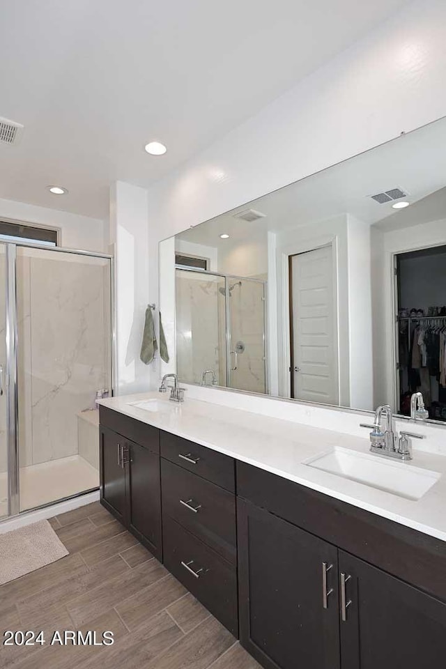 bathroom with walk in shower and vanity