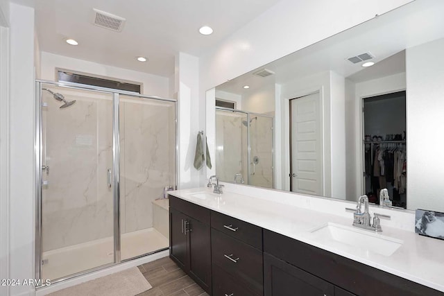 bathroom with an enclosed shower and vanity