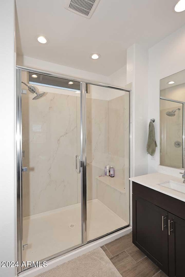 bathroom featuring an enclosed shower and vanity