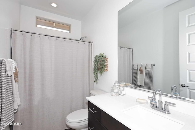 bathroom with toilet and vanity