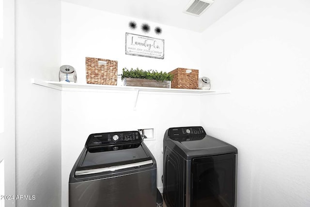 washroom with washing machine and clothes dryer