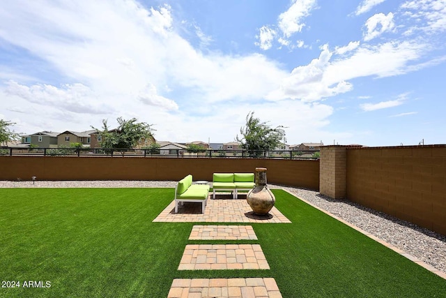 view of yard with an outdoor living space with a fire pit and a patio area