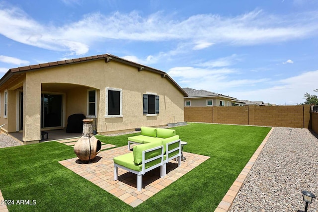 rear view of property featuring a patio area, a yard, and an outdoor living space