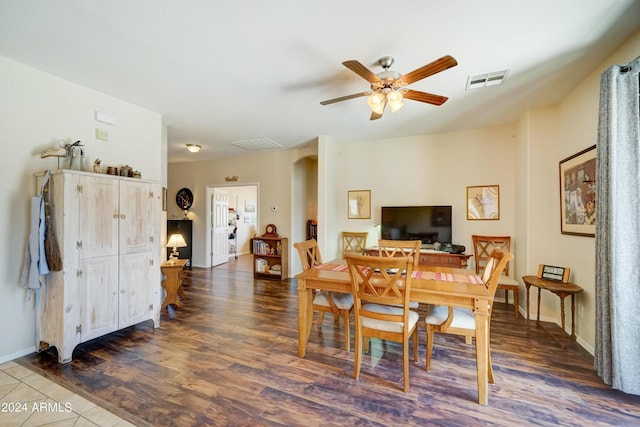 dining space featuring ceiling fan and dark hardwood / wood-style floors