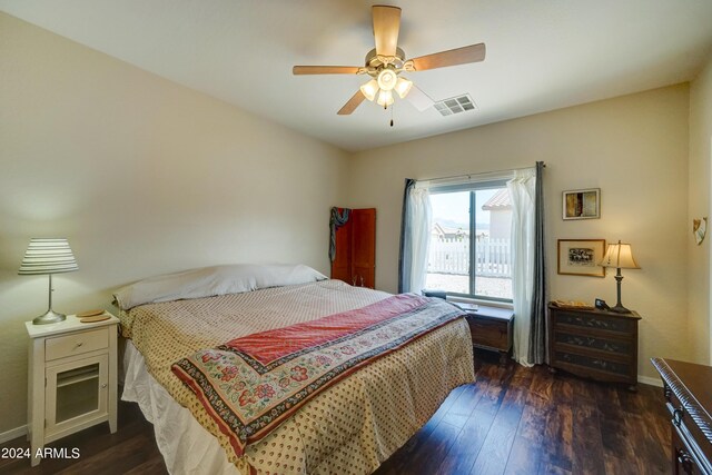 bedroom with dark hardwood / wood-style floors and ceiling fan