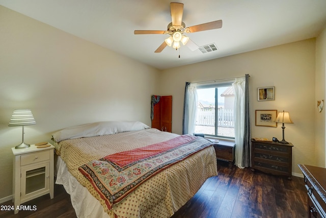 bedroom with dark hardwood / wood-style floors and ceiling fan