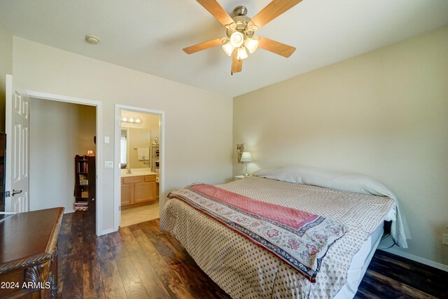 bedroom featuring ceiling fan, dark wood-type flooring, and ensuite bath