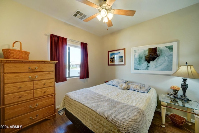 bedroom with ceiling fan and dark hardwood / wood-style floors