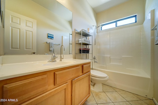 full bathroom featuring washtub / shower combination, vanity, tile patterned flooring, and toilet