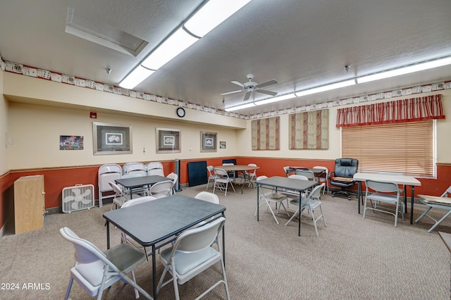 interior space with ceiling fan and carpet flooring