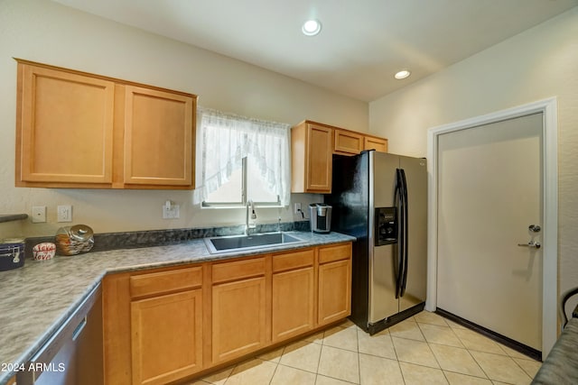 kitchen with light tile patterned floors, stainless steel appliances, and sink