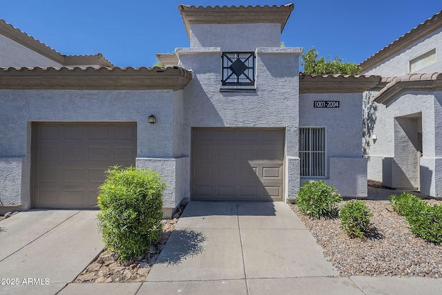 3236 E Chandler Blvd Unit 2003, Phoenix, AZ 85048 - view of front of property with stucco siding, concrete driveway, and a tiled roof