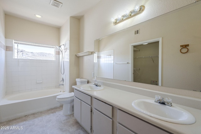 3236 E Chandler Blvd Unit 2003, Phoenix, AZ 85048 - full bath featuring toilet, double vanity, tile patterned floors,  shower combination, and a spacious closet