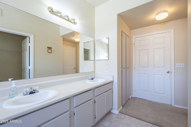 3236 E Chandler Blvd Unit 2003, Phoenix, AZ 85048 - full bath with a closet, double vanity, baseboards, and tile patterned floors