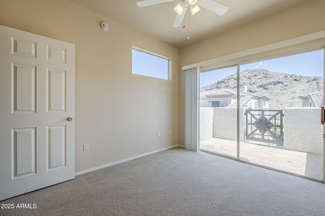 3236 E Chandler Blvd Unit 2003, Phoenix, AZ 85048 - spare room featuring a mountain view, a ceiling fan, carpet flooring, and baseboards