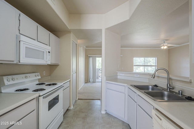 3236 E Chandler Blvd Unit 2003, Phoenix, AZ 85048 - kitchen featuring white appliances, a sink, light countertops, white cabinets, and crown molding
