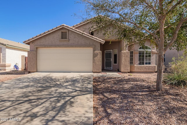 1619 E Aspen Ave, Buckeye, AZ 85326 - view of front facade with driveway, stucco siding, and an attached garage