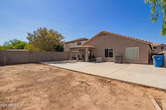 1619 E Aspen Ave, Buckeye, AZ 85326 - rear view of house featuring stucco siding, a patio area, and a fenced backyard