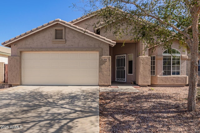1619 E Aspen Ave, Buckeye, AZ 85326 - view of front of property featuring concrete driveway, an attached garage, and stucco siding