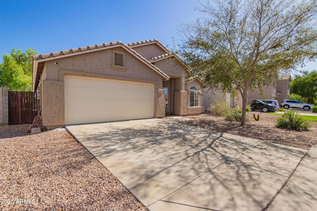 1619 E Aspen Ave, Buckeye, AZ 85326 - view of front of home with driveway, an attached garage, stucco siding, and a tiled roof