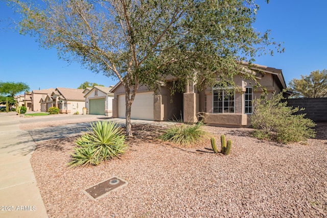 1619 E Aspen Ave, Buckeye, AZ 85326 - view of front of property with driveway, stucco siding, and a garage