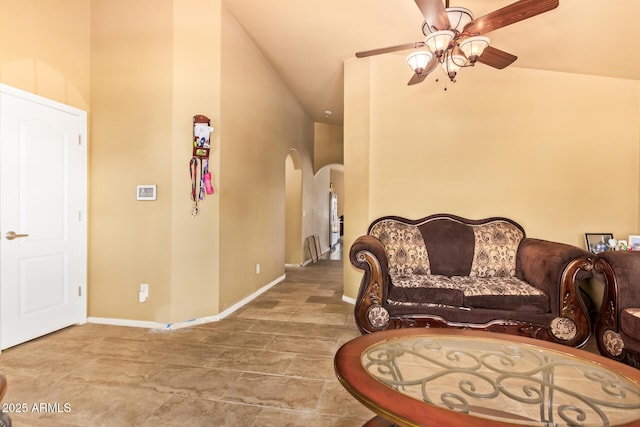 1619 E Aspen Ave, Buckeye, AZ 85326 - living area featuring arched walkways, ceiling fan, and a high ceiling
