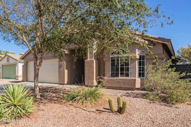1619 E Aspen Ave, Buckeye, AZ 85326 - view of front facade with a garage, driveway, and stucco siding