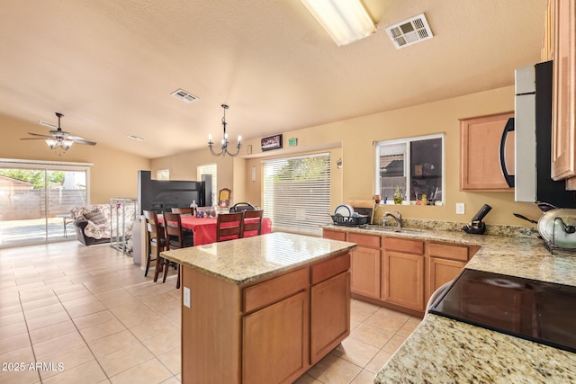 1619 E Aspen Ave, Buckeye, AZ 85326 - kitchen featuring light tile patterned floors, a chandelier, light stone countertops, a center island, and lofted ceiling