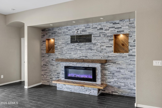 unfurnished living room featuring a stone fireplace