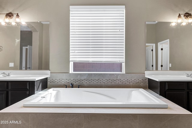 bathroom with vanity and tiled tub