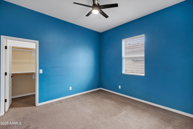 carpeted empty room featuring ceiling fan