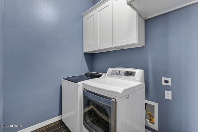 laundry room featuring independent washer and dryer and cabinets