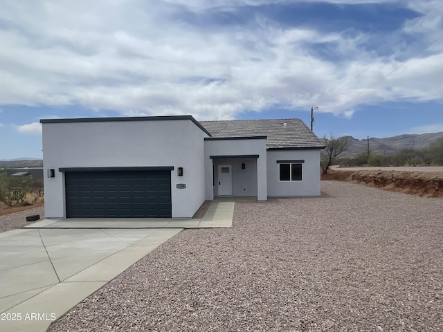 1825 Via Nueva Zelandia, Rio Rico, AZ 85648 - contemporary home with a garage, concrete driveway, stucco siding, and a mountain view