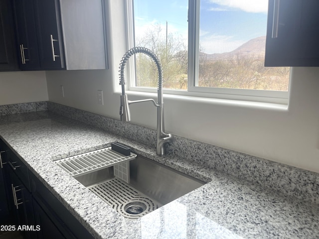 1825 Via Nueva Zelandia, Rio Rico, AZ 85648 - kitchen view of a sink, dark cabinetry, and a mountain backdrop