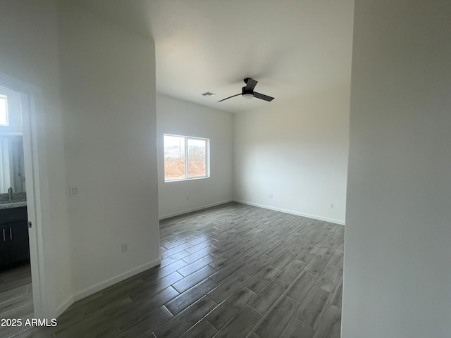 1825 Via Nueva Zelandia, Rio Rico, AZ 85648 - spare room featuring dark wood-type flooring, a ceiling fan, and baseboards