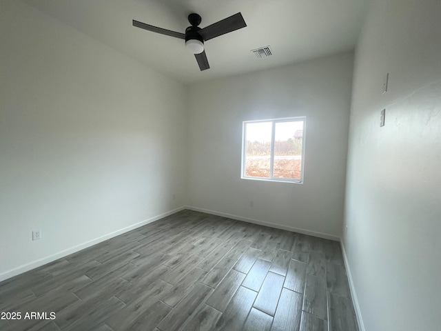 1825 Via Nueva Zelandia, Rio Rico, AZ 85648 - spare room with dark wood finished floors, baseboards, and a ceiling fan