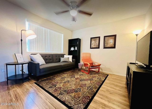 living room featuring light hardwood / wood-style floors and ceiling fan