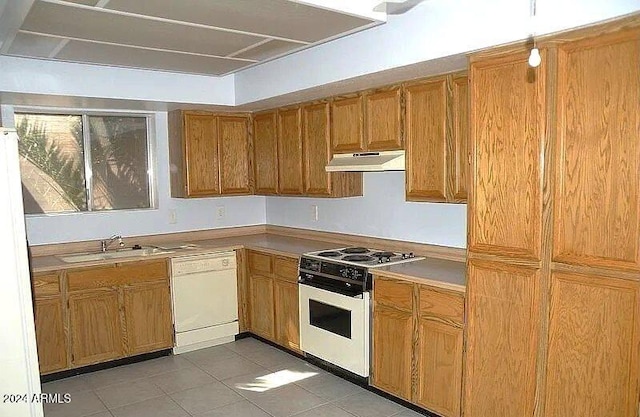 kitchen featuring sink, light tile patterned floors, and white appliances