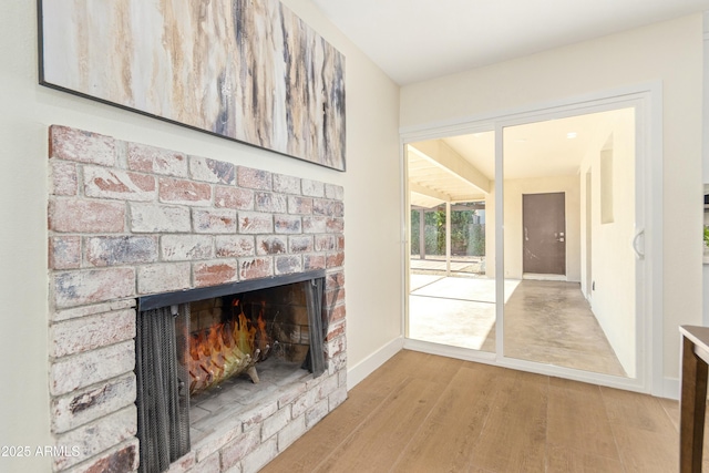 unfurnished living room featuring a fireplace and light hardwood / wood-style floors