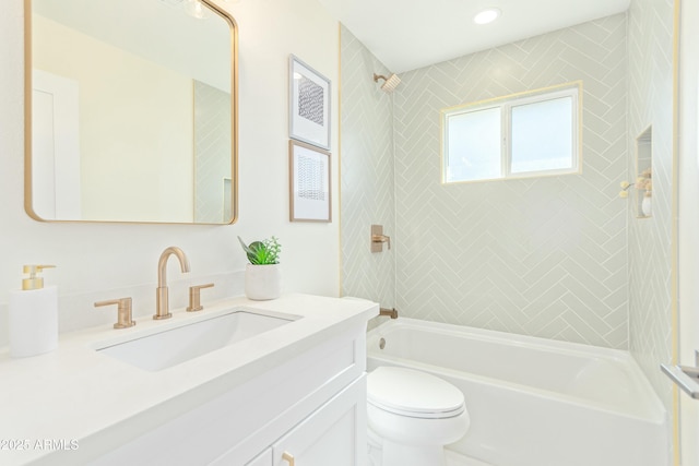 full bathroom featuring vanity, toilet, and tiled shower / bath