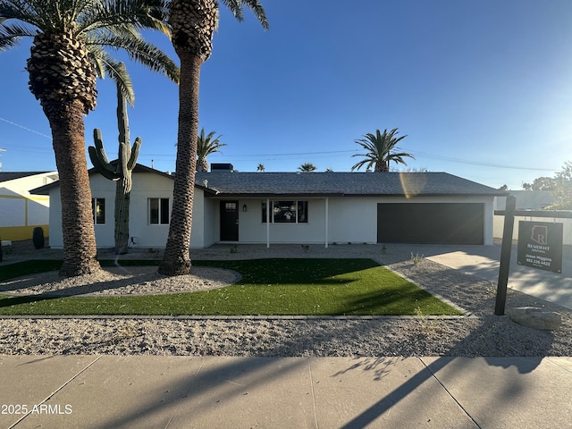 view of front of house with a front yard and a garage