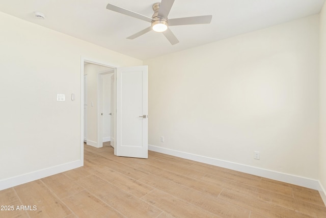 empty room featuring ceiling fan and light hardwood / wood-style floors