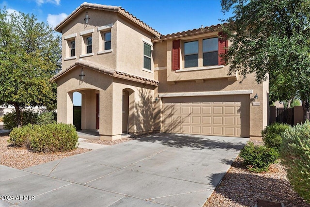 mediterranean / spanish house featuring a garage