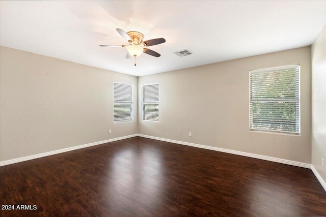 empty room featuring ceiling fan and dark hardwood / wood-style floors